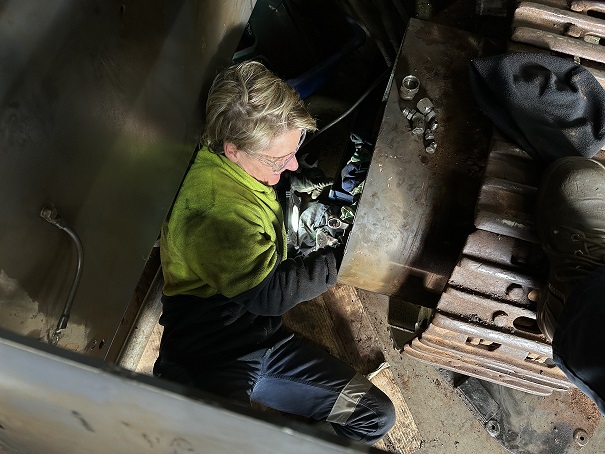 Female trade mechanic apprentice working